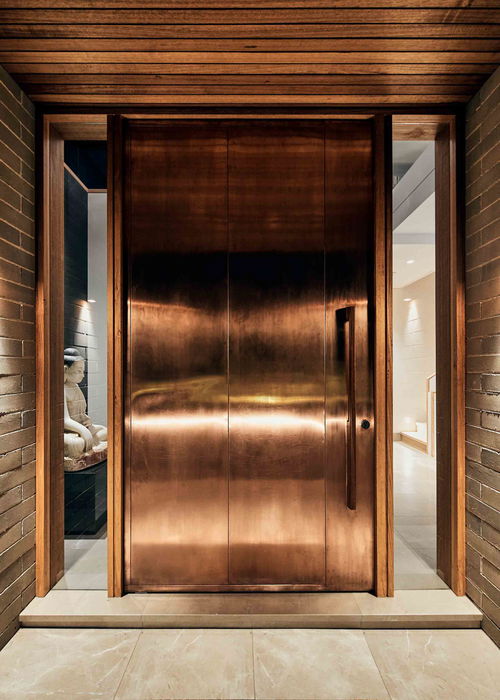 Copper cladded pivot door with FritsJurgens pivot hinge System M