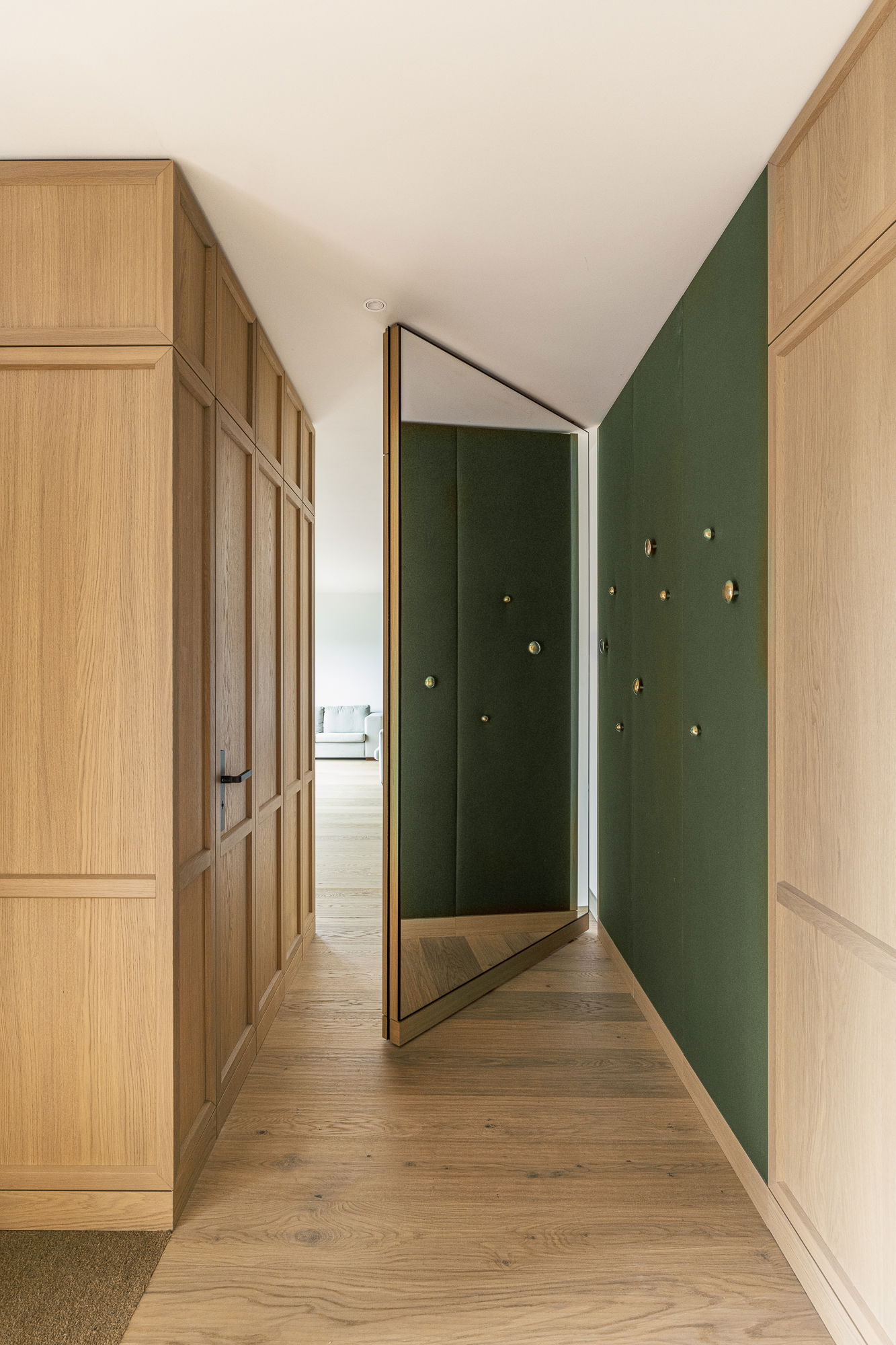 One side of this door mirrors the wall panelling; the other reflects a mirrored surface.