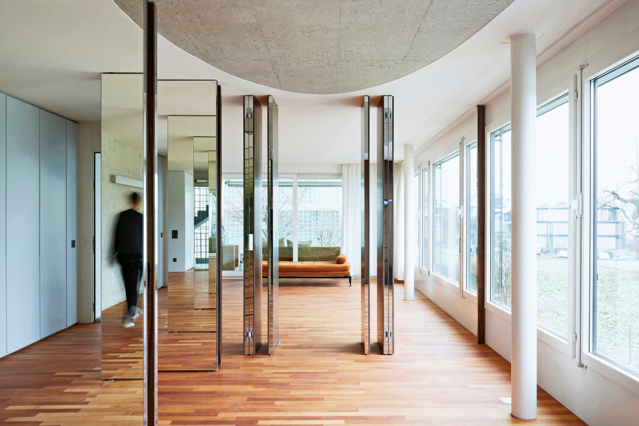 Mirrored pivot door in a private home with FritsJurgens System M pivot hinge system inside