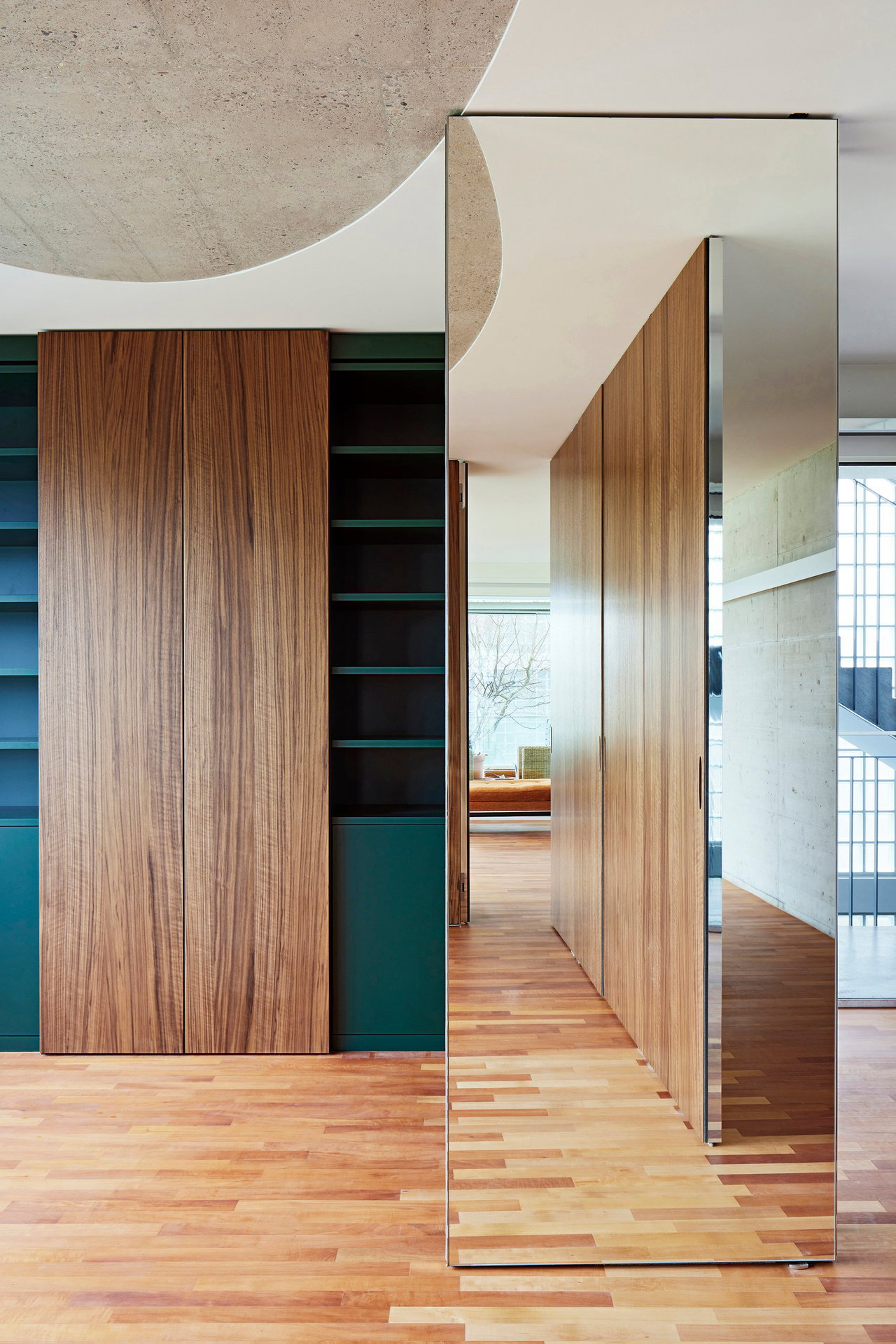 Mirrored pivot door in a private home with FritsJurgens System M pivot hinge system inside