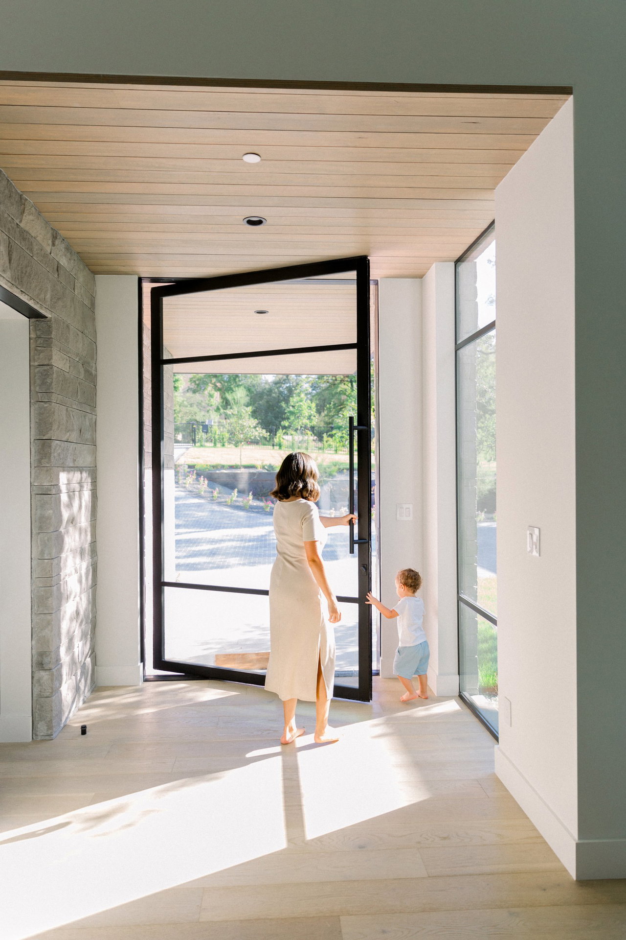 Steel and glass pivot door in a private home in West Lake Hills with FritsJurgens System One pivot hinge system inside