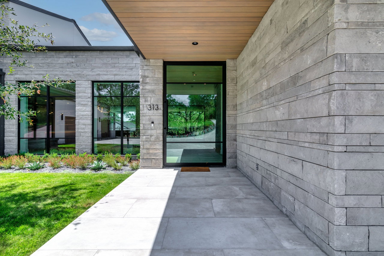 Steel and glass pivot door in a private home in West Lake Hills with FritsJurgens System One pivot hinge system inside