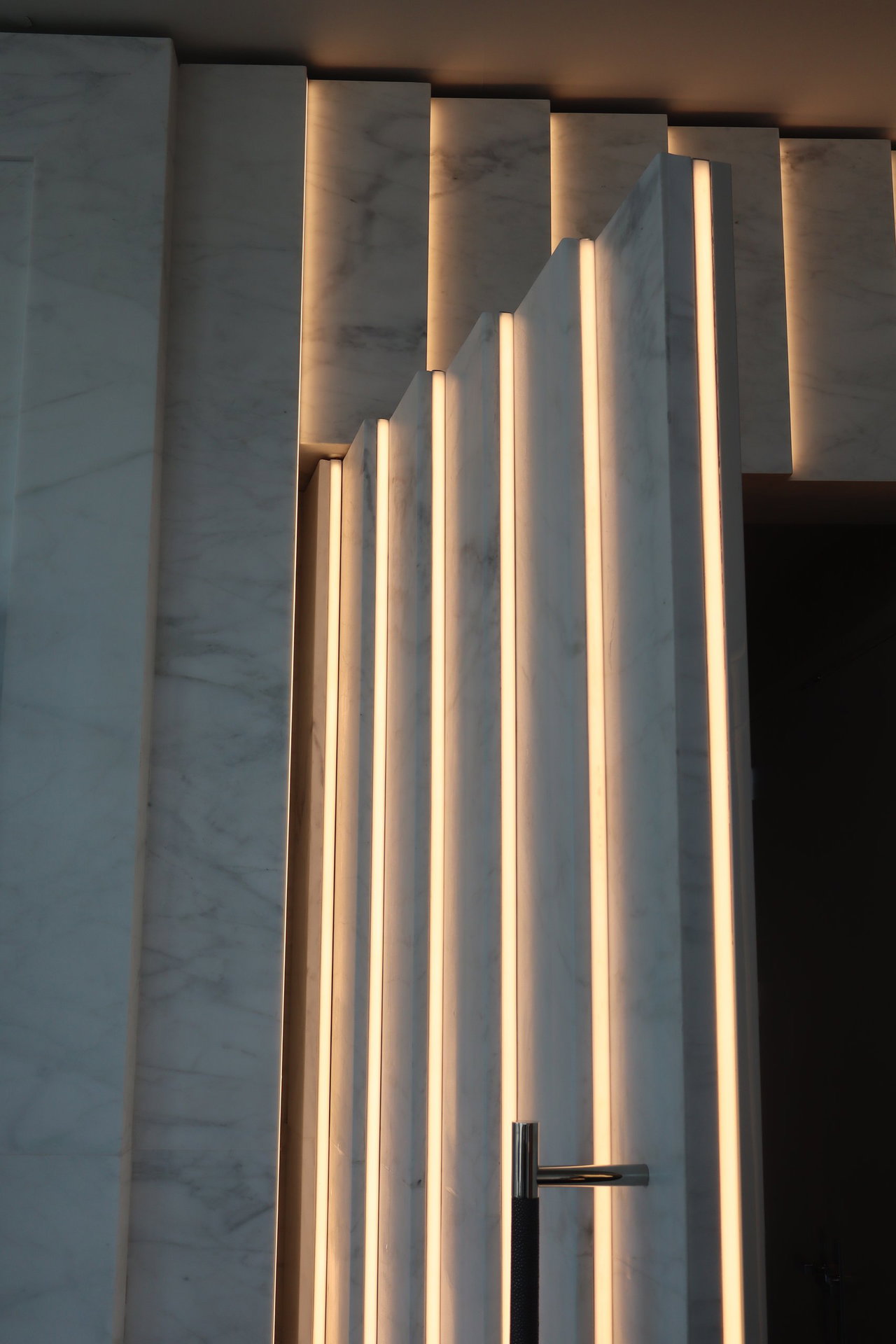 Marble pivot door in a private home in New York City with FritsJurgens System M+ pivot hinge system inside