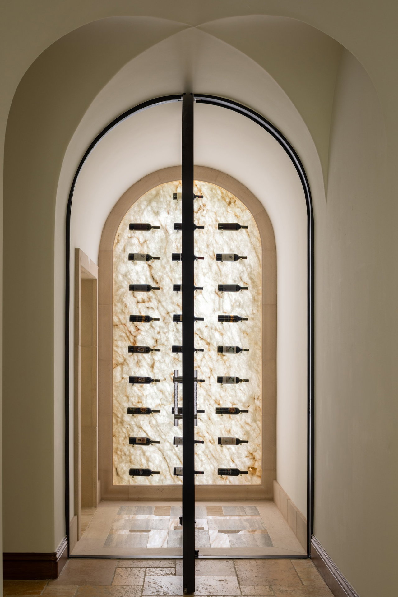 Steel and glass pivot door in a private home in Rancho Santa Fe with FritsJurgens System One pivot hinge system inside
