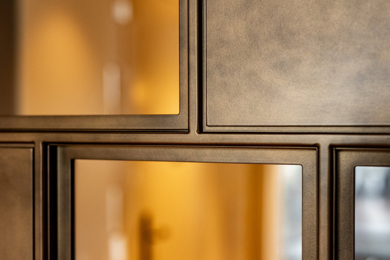 Steel and glass pivot door in a private home in Amsterdam with FritsJurgens System M pivot hinge system inside