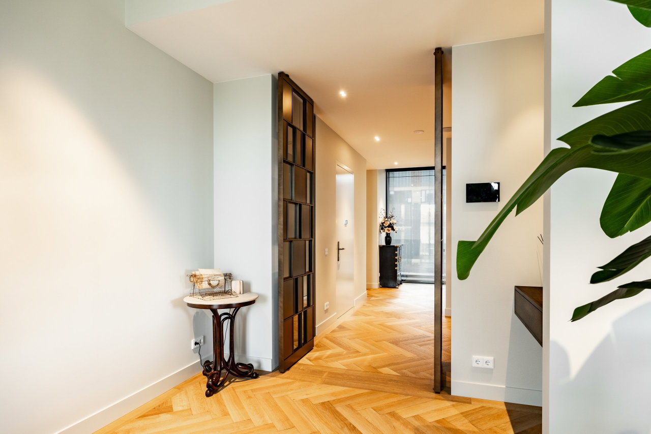 Steel and glass pivot door in a private home in Amsterdam with FritsJurgens System M pivot hinge system inside