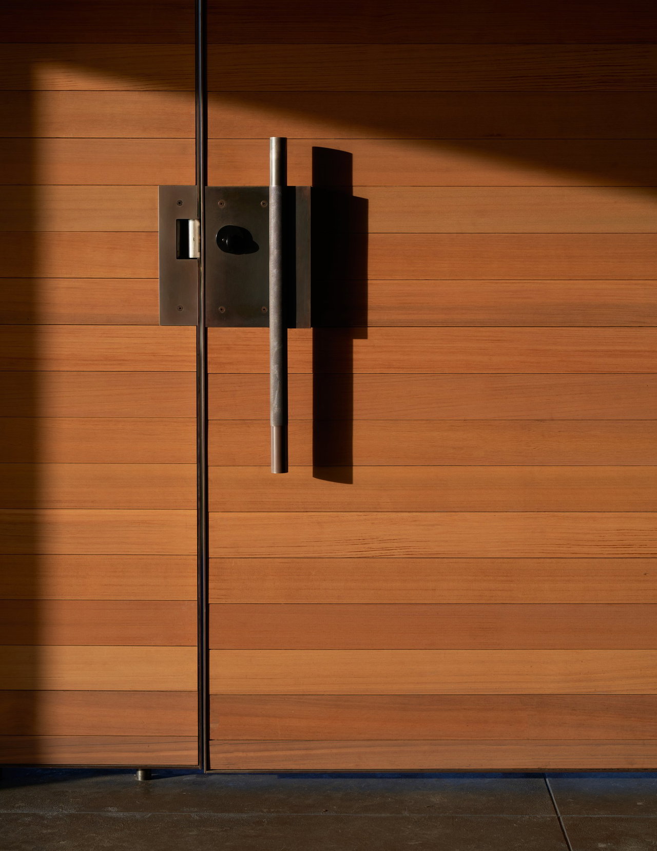 Wooden pivot door in a private home in Seattle with FritsJurgens System M pivot hinge system inside