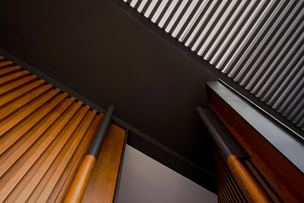 Wooden pivot door in a private home in Jakarta with FritsJurgens System M+ pivot hinge system inside