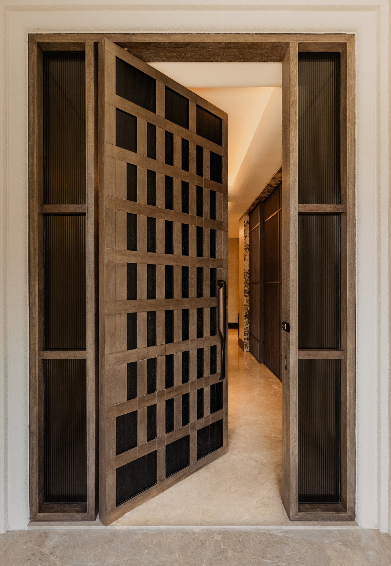 Wooden pivot door in a private home in Jakarta with FritsJurgens System M+ pivot hinge system inside
