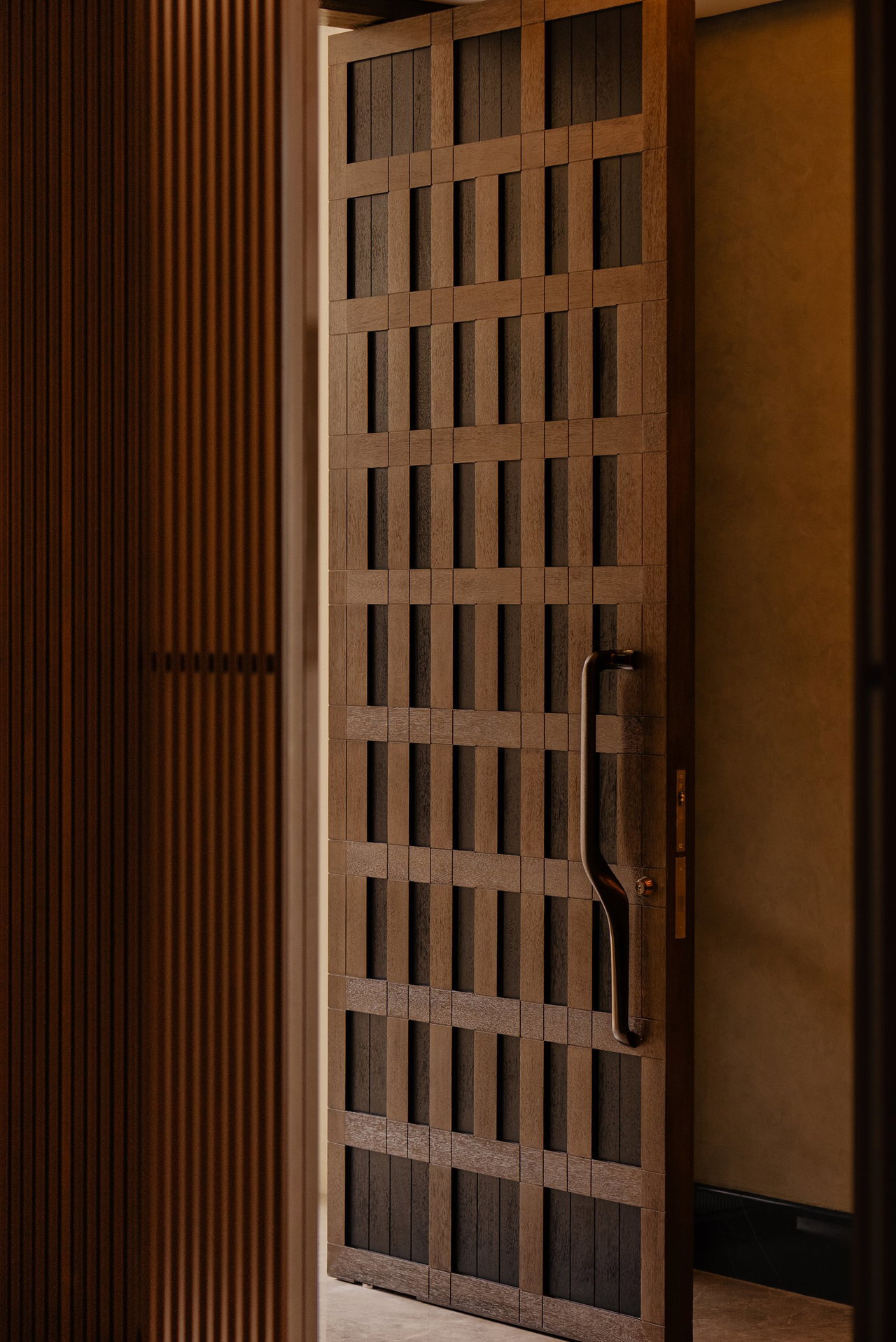 Wooden pivot door in a private home in Jakarta with FritsJurgens System M+ pivot hinge system inside