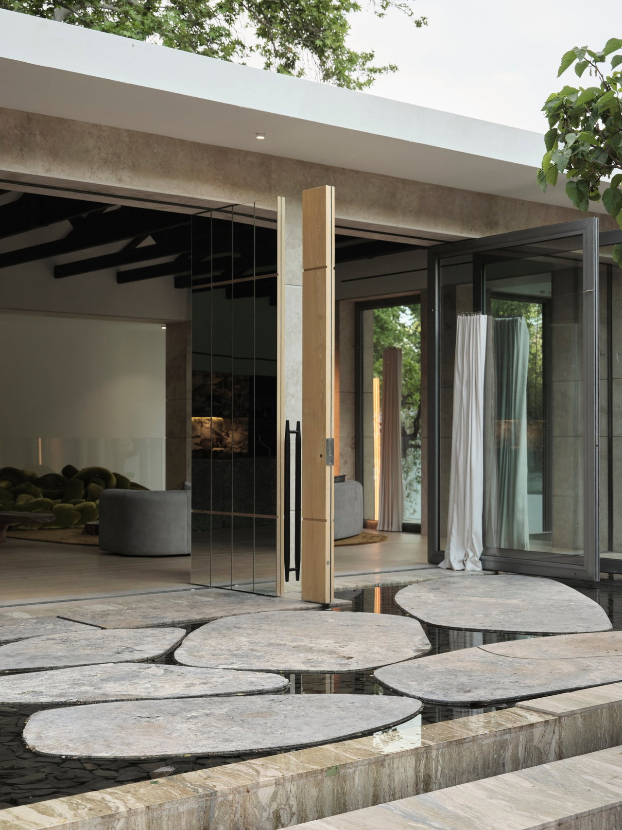 Mirrored pivot door in a private home in New York with FritsJurgens System M+ pivot hinge system inside