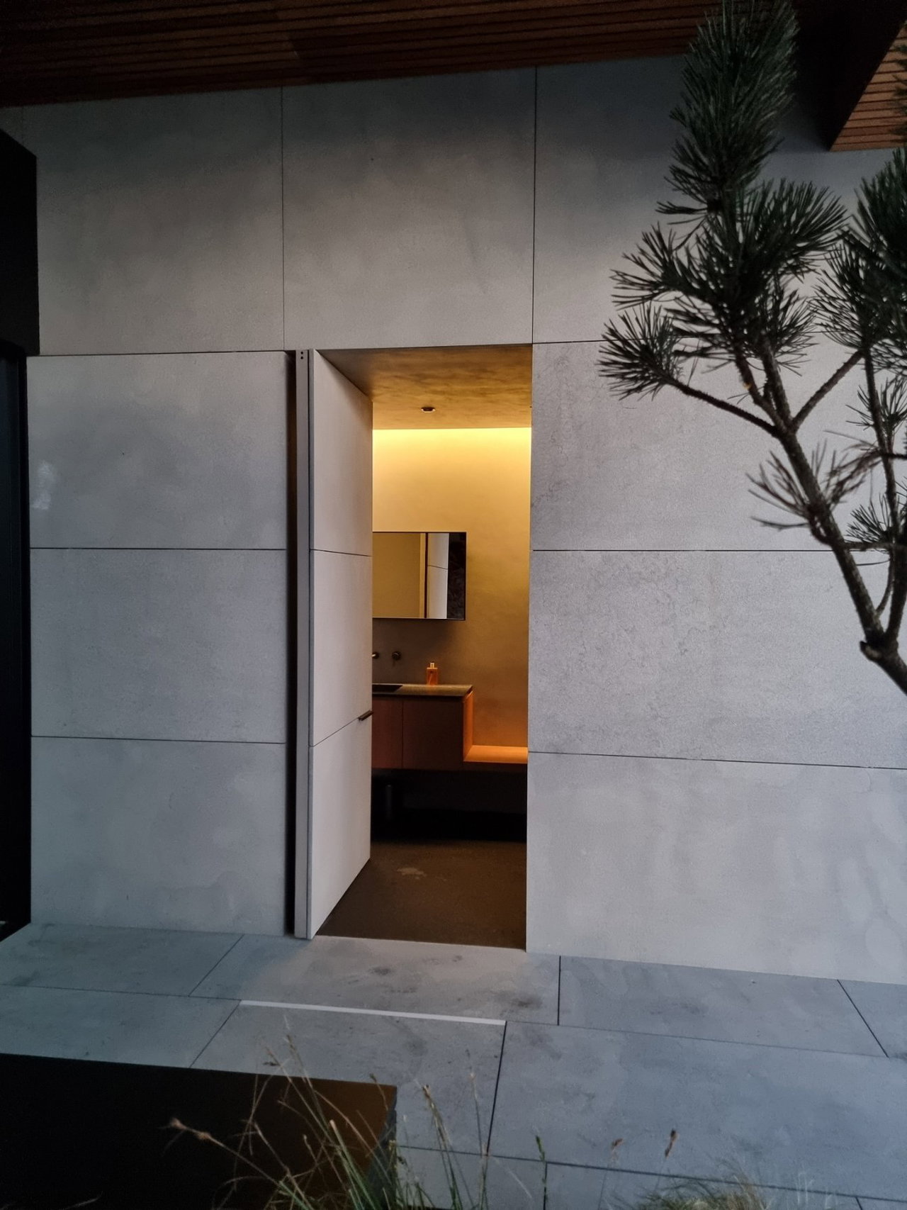 Stone pivot door in a private home in Cangas do Morrazo with FritsJurgens System M+ pivot hinge system inside