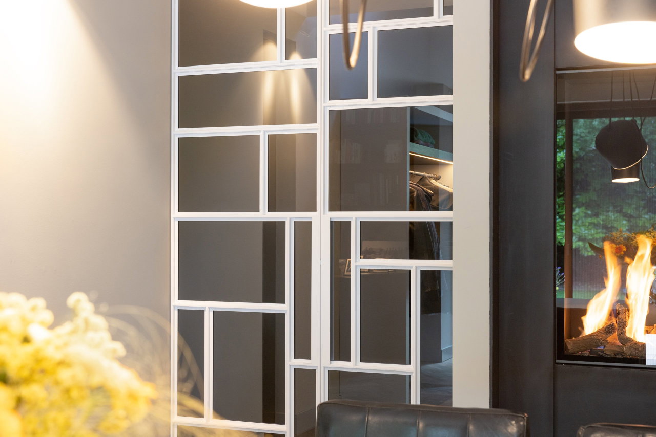 Steel and glass pivot door in a private home in Geldrop with FritsJurgens System M+ pivot hinge system inside
