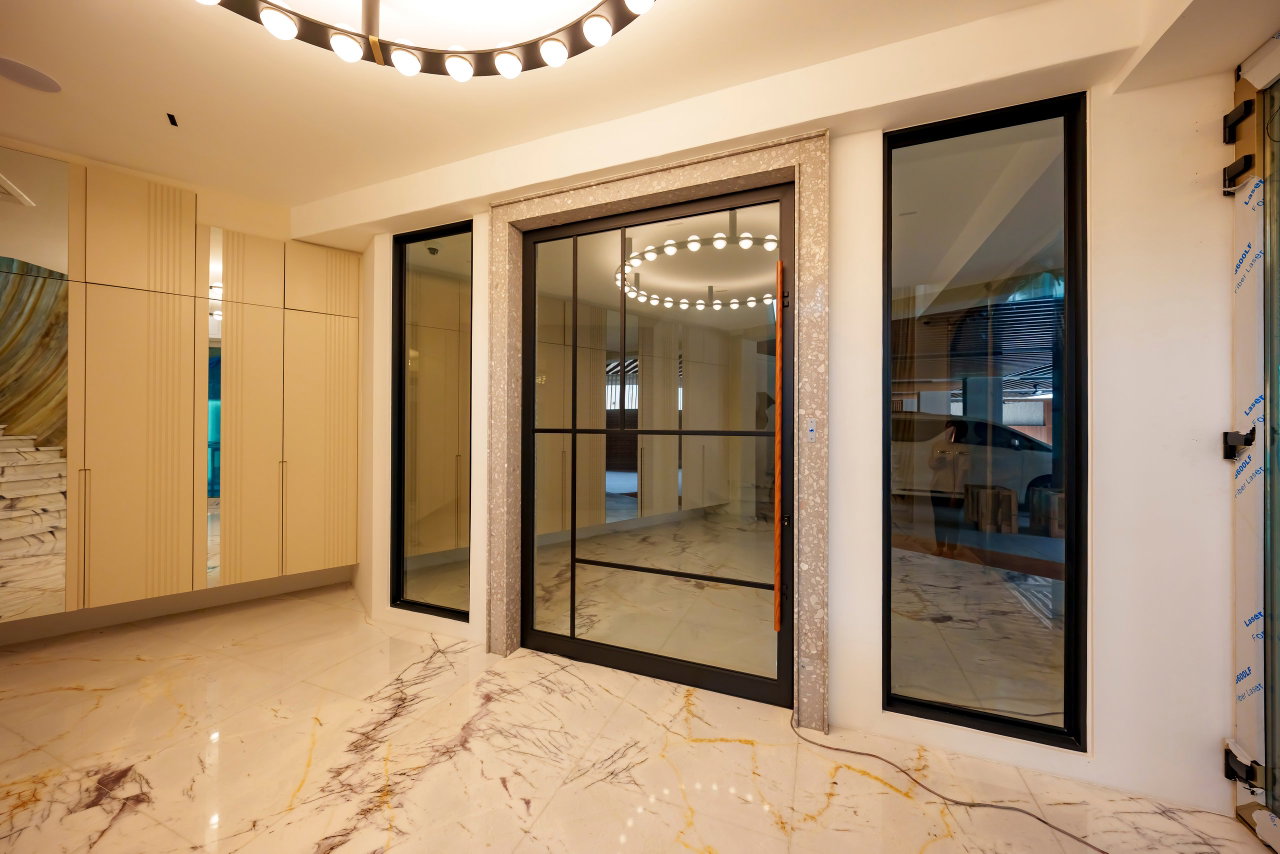 Steel and glass pivot door in a private home in Sierramas with FritsJurgens System M+ pivot hinge system inside