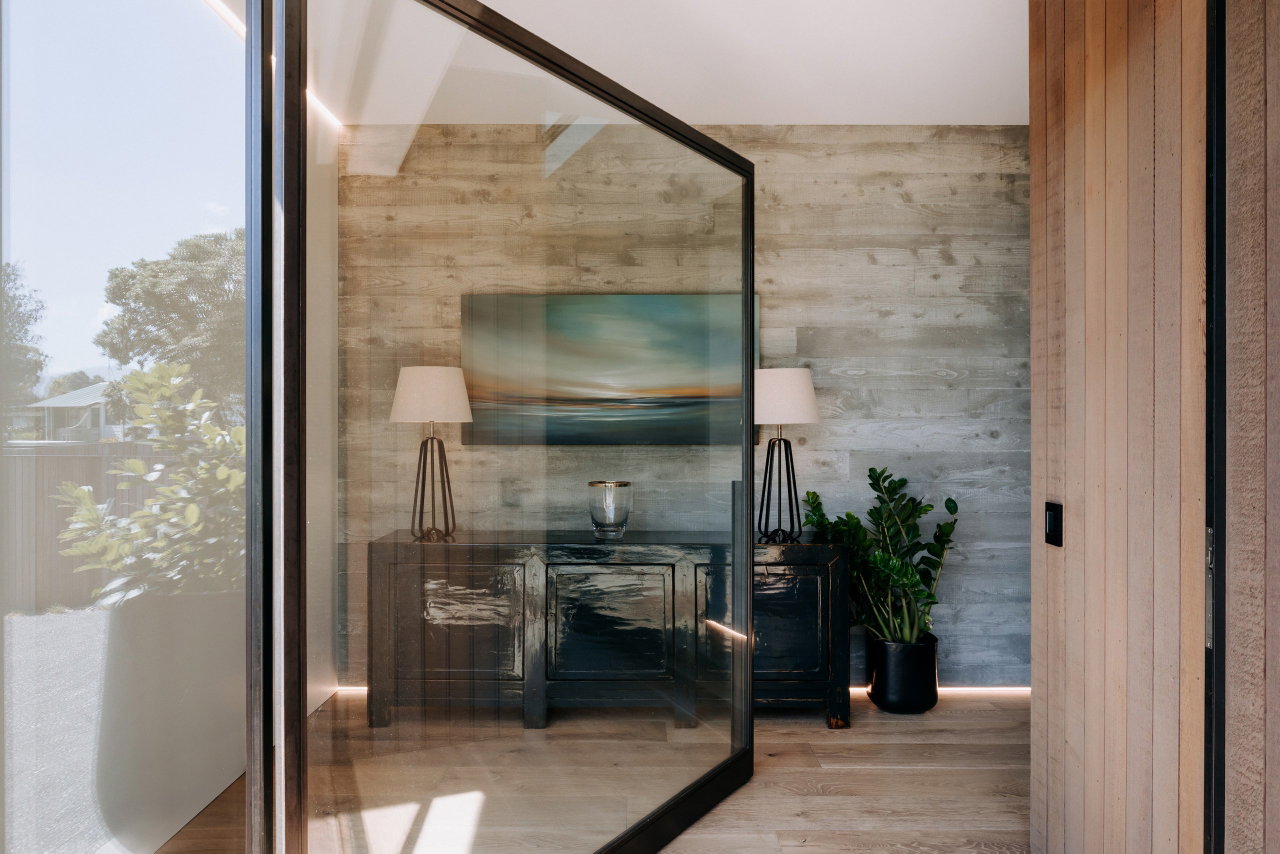 Steel and glass pivot door in a private home in Bowentown with FritsJurgens System M+ pivot hinge system inside