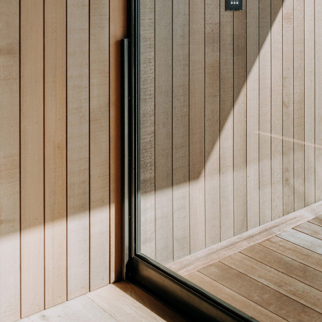 Steel and glass pivot door in a private home in Bowentown with FritsJurgens System M+ pivot hinge system inside