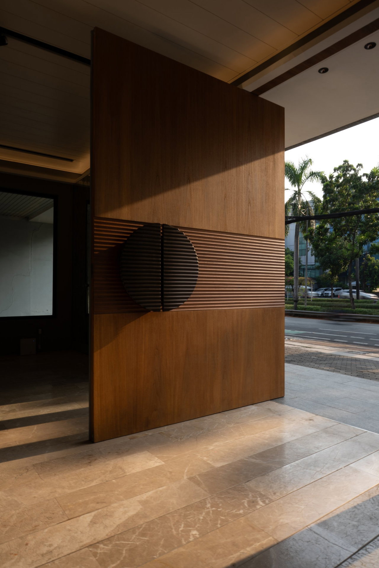 Wooden pivot door in a private home in Jakarta with FritsJurgens System One pivot hinge system inside