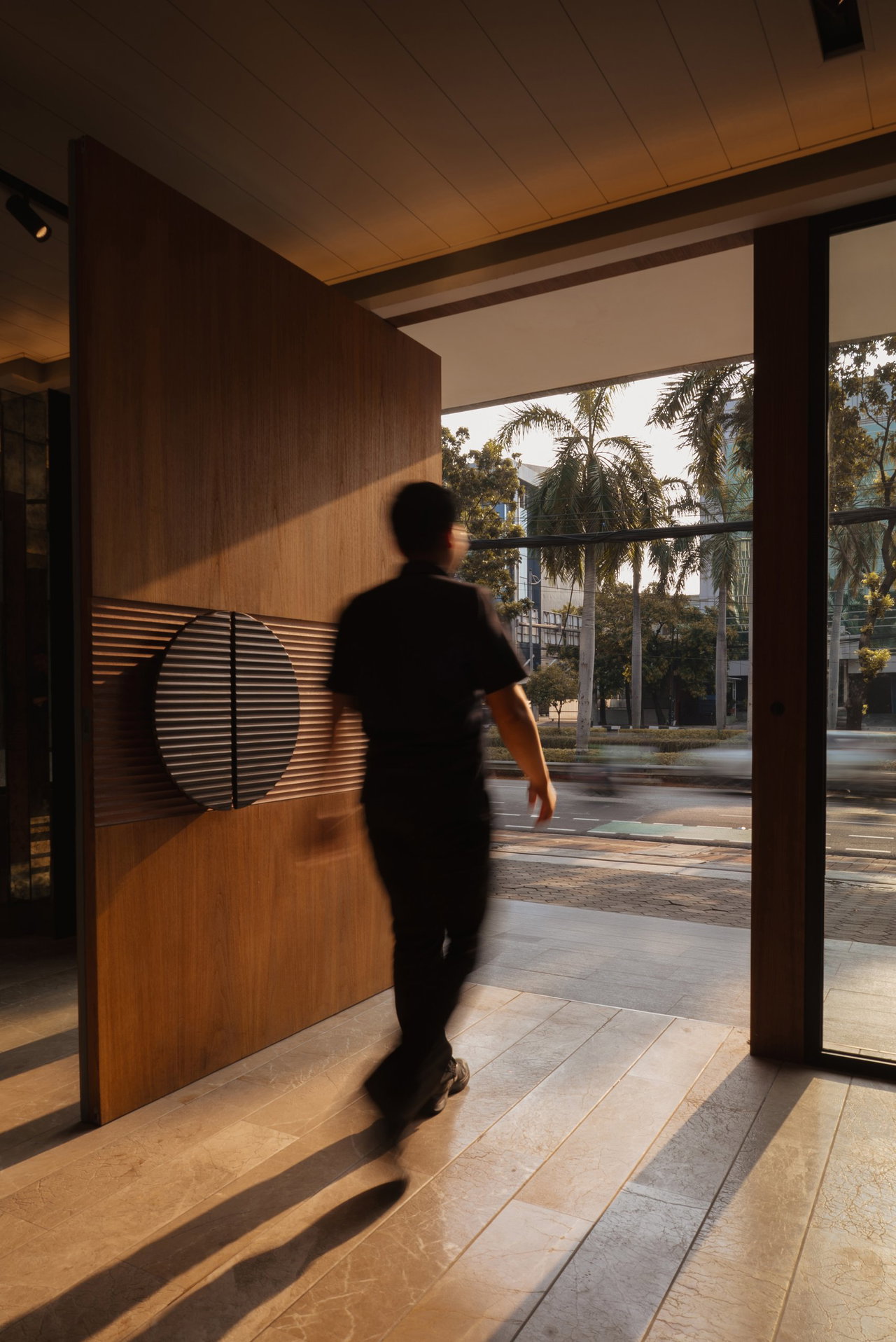 Wooden pivot door in a private home in Jakarta with FritsJurgens System One pivot hinge system inside