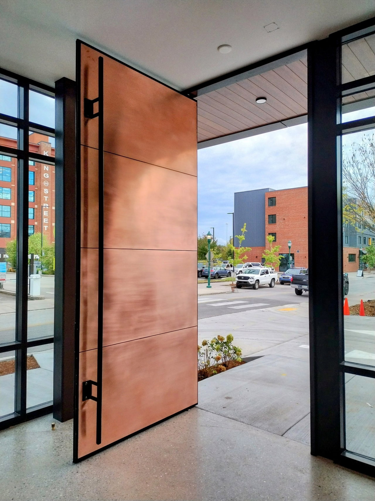 Composite pivot door in an office in Chattanooga with FritsJurgens System M+ pivot hinge system inside