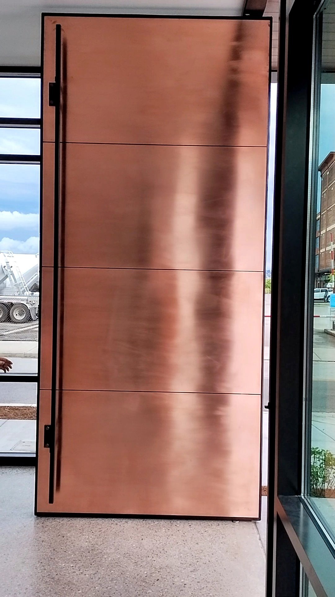 Composite pivot door in an office in Chattanooga with FritsJurgens System M+ pivot hinge system inside
