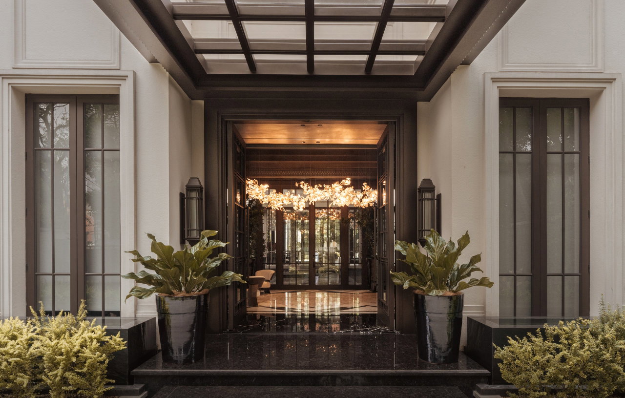 Steel and glass pivot door in a private home in Jakarta with FritsJurgens System M+ pivot hinge system inside