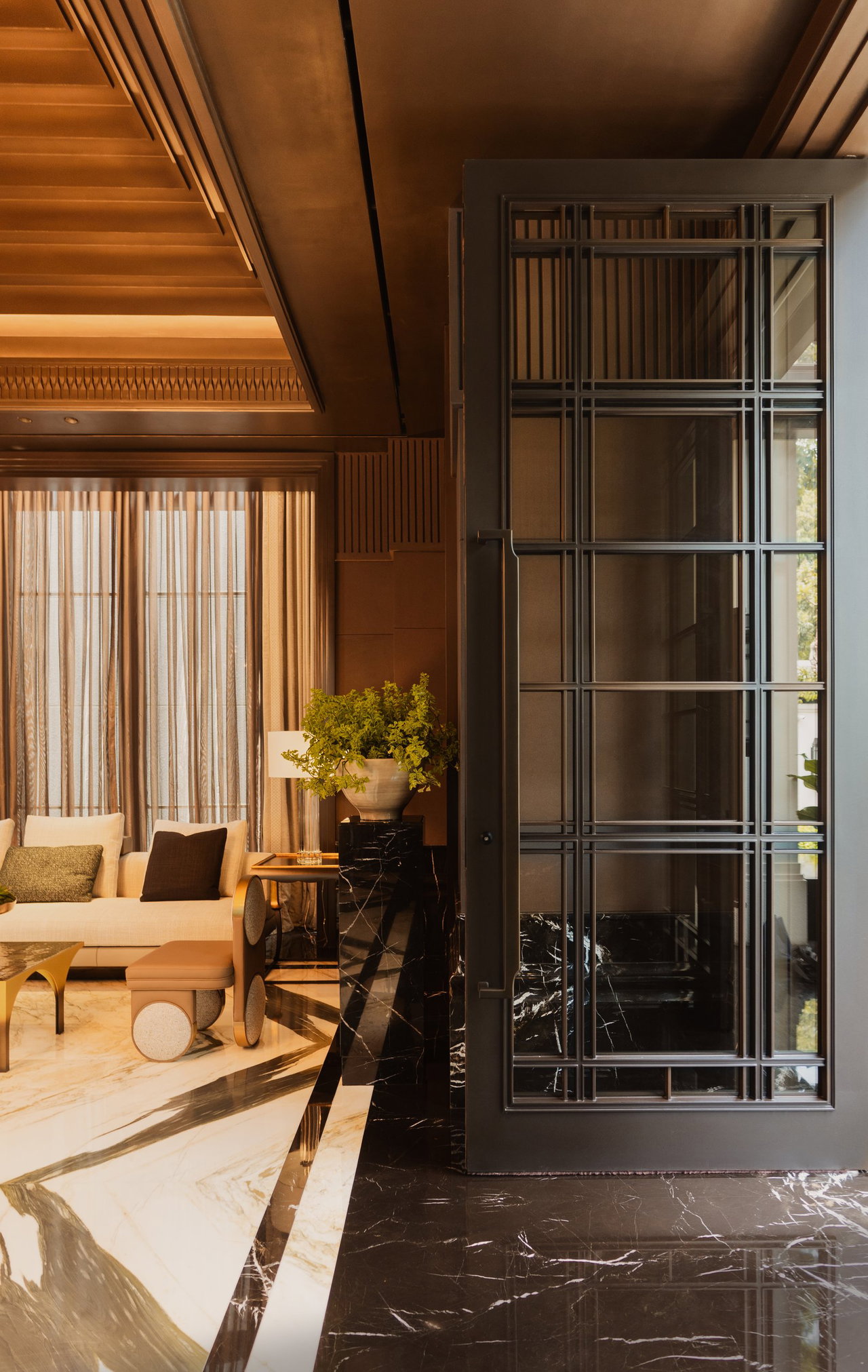 Steel and glass pivot door in a private home in Jakarta with FritsJurgens System M+ pivot hinge system inside