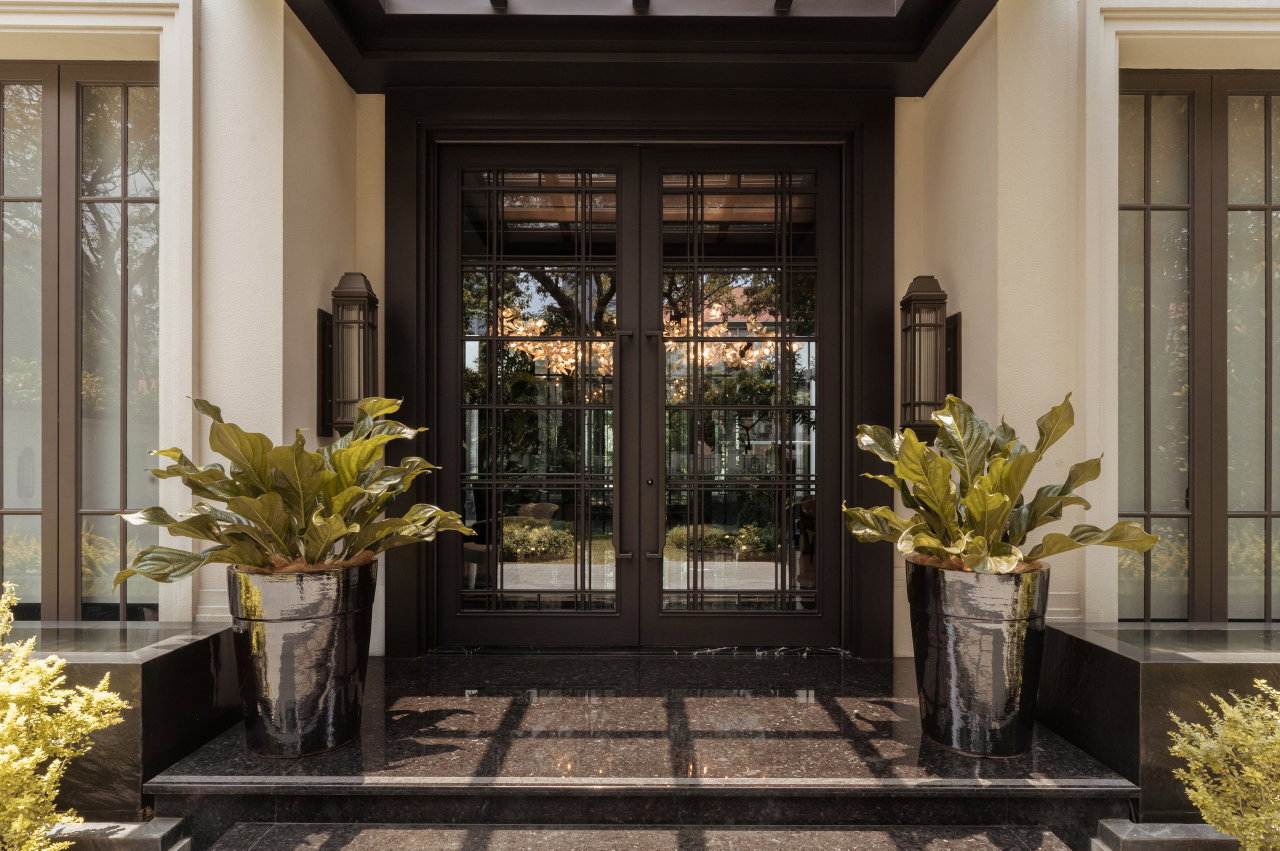 Steel and glass pivot door in a private home in Jakarta with FritsJurgens System M+ pivot hinge system inside