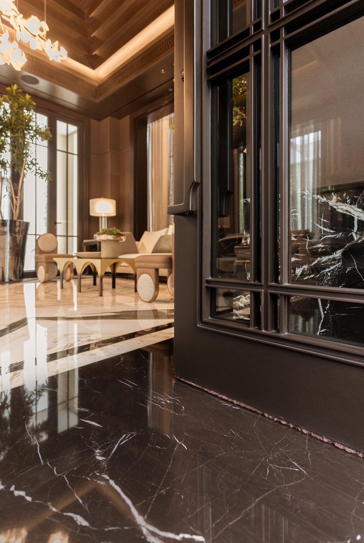 Steel and glass pivot door in a private home in Jakarta with FritsJurgens System M+ pivot hinge system inside