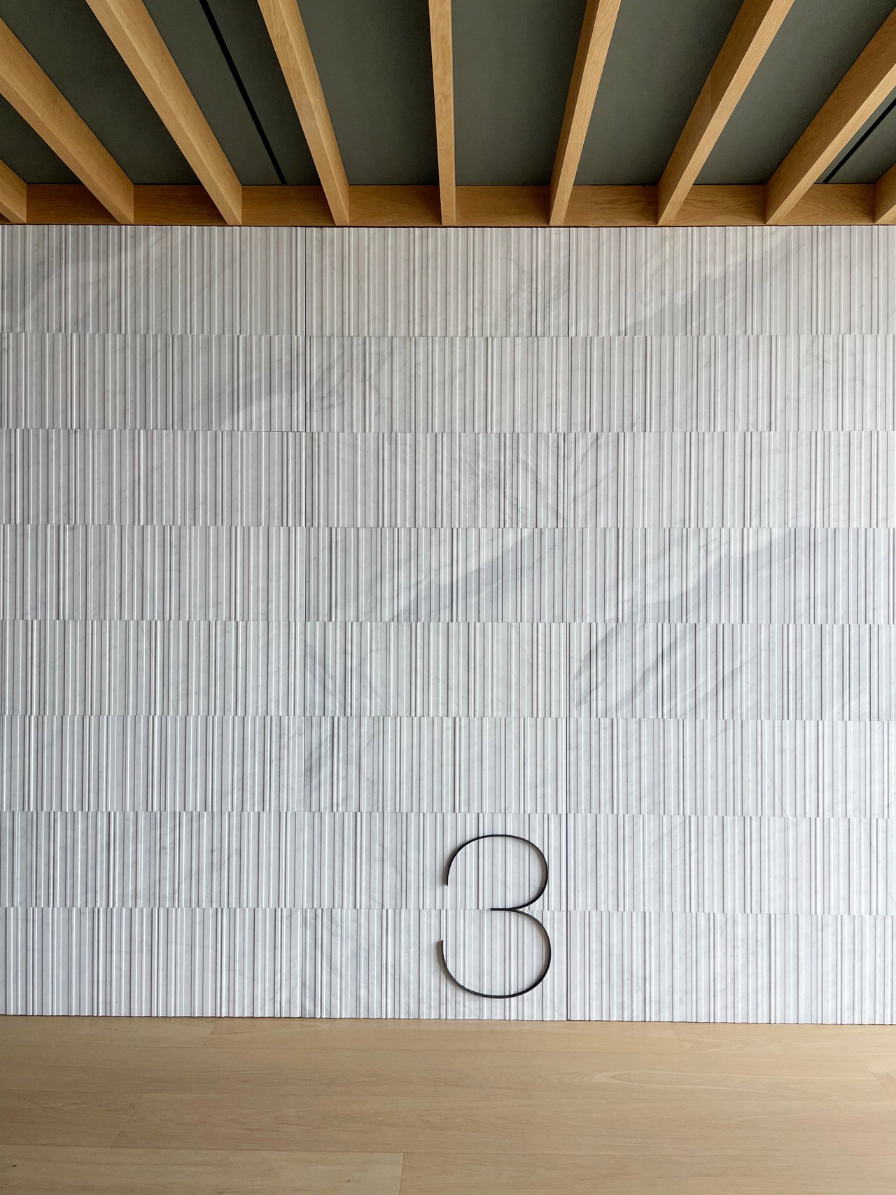 Stone pivot door in an office in Madrid with FritsJurgens System M+ pivot hinge system inside
