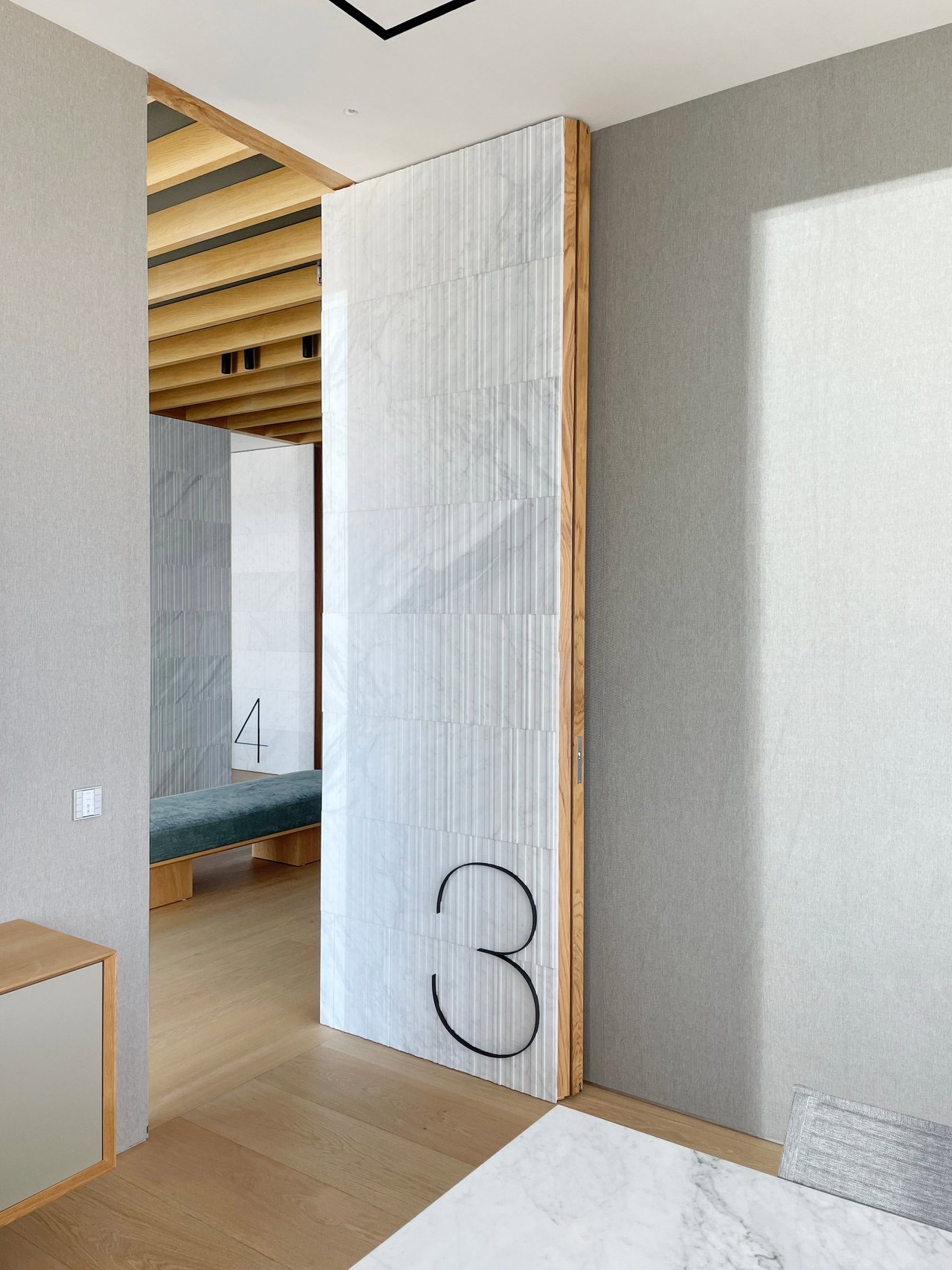 Stone pivot door in an office in Madrid with FritsJurgens System M+ pivot hinge system inside
