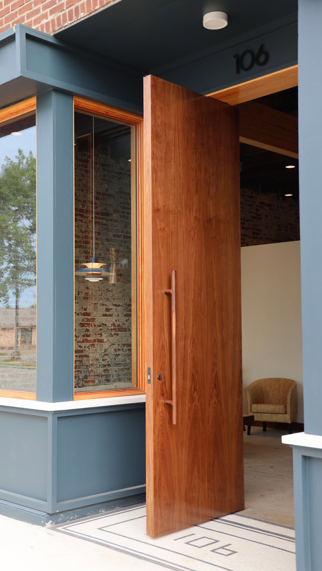 Wooden pivot door in an office in Athens with FritsJurgens System M+ pivot hinge system inside