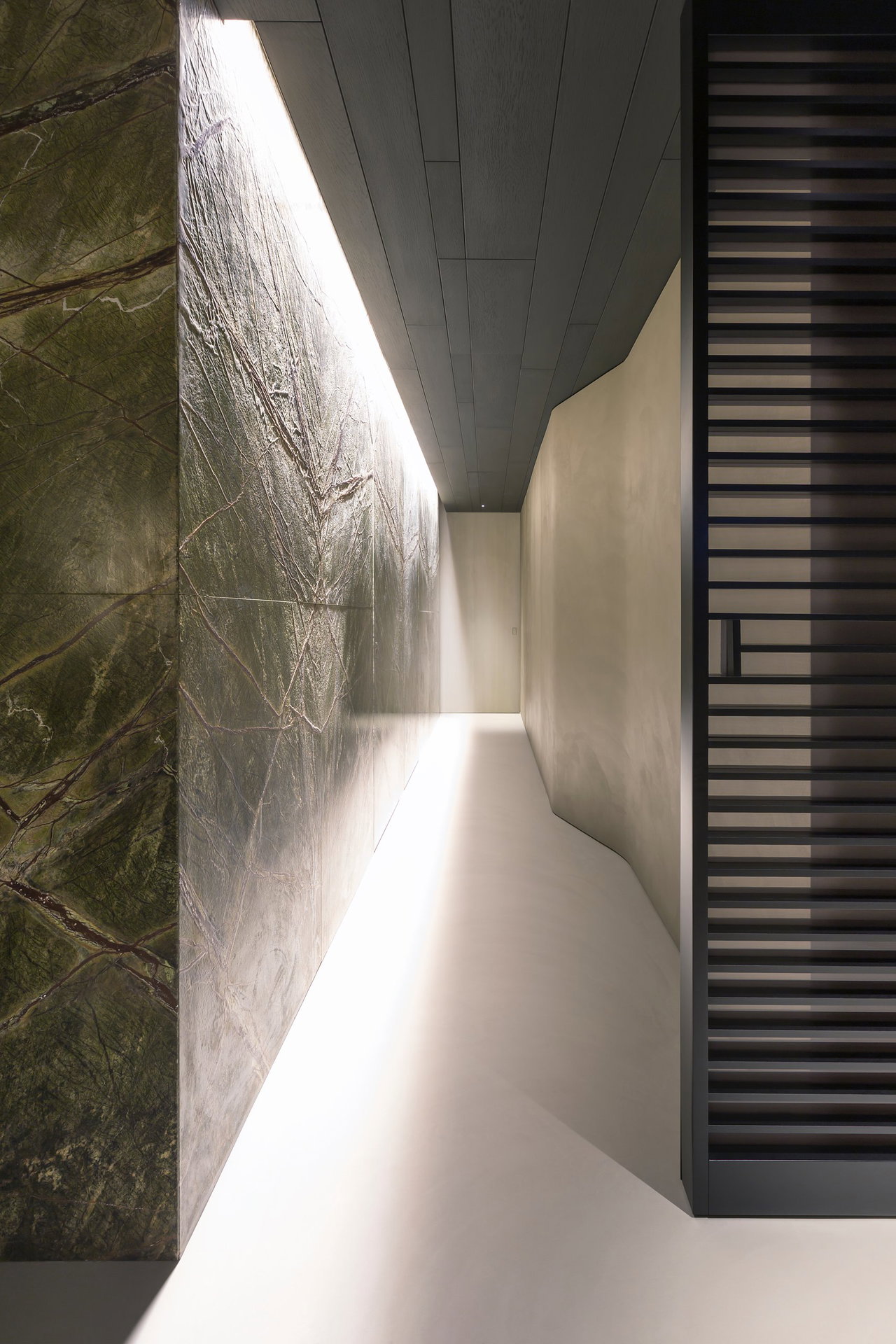 Marble pivot door in a private home in Milan with FritsJurgens System 3 pivot hinge system inside
