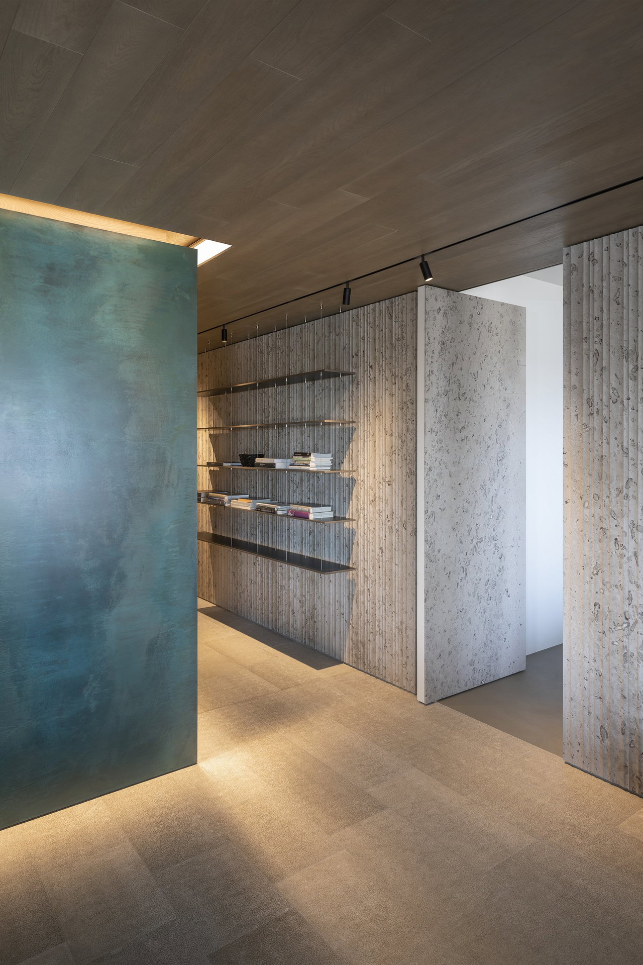 Stone pivot door in a private home in Portopiccolo with FritsJurgens System M pivot hinge system inside