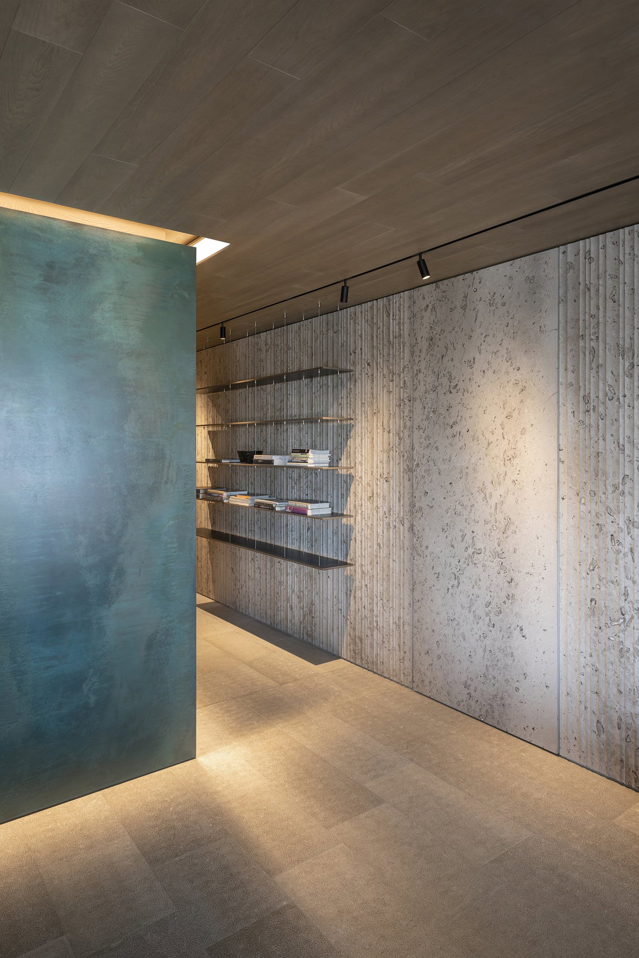 Stone pivot door in a private home in Portopiccolo with FritsJurgens System M pivot hinge system inside