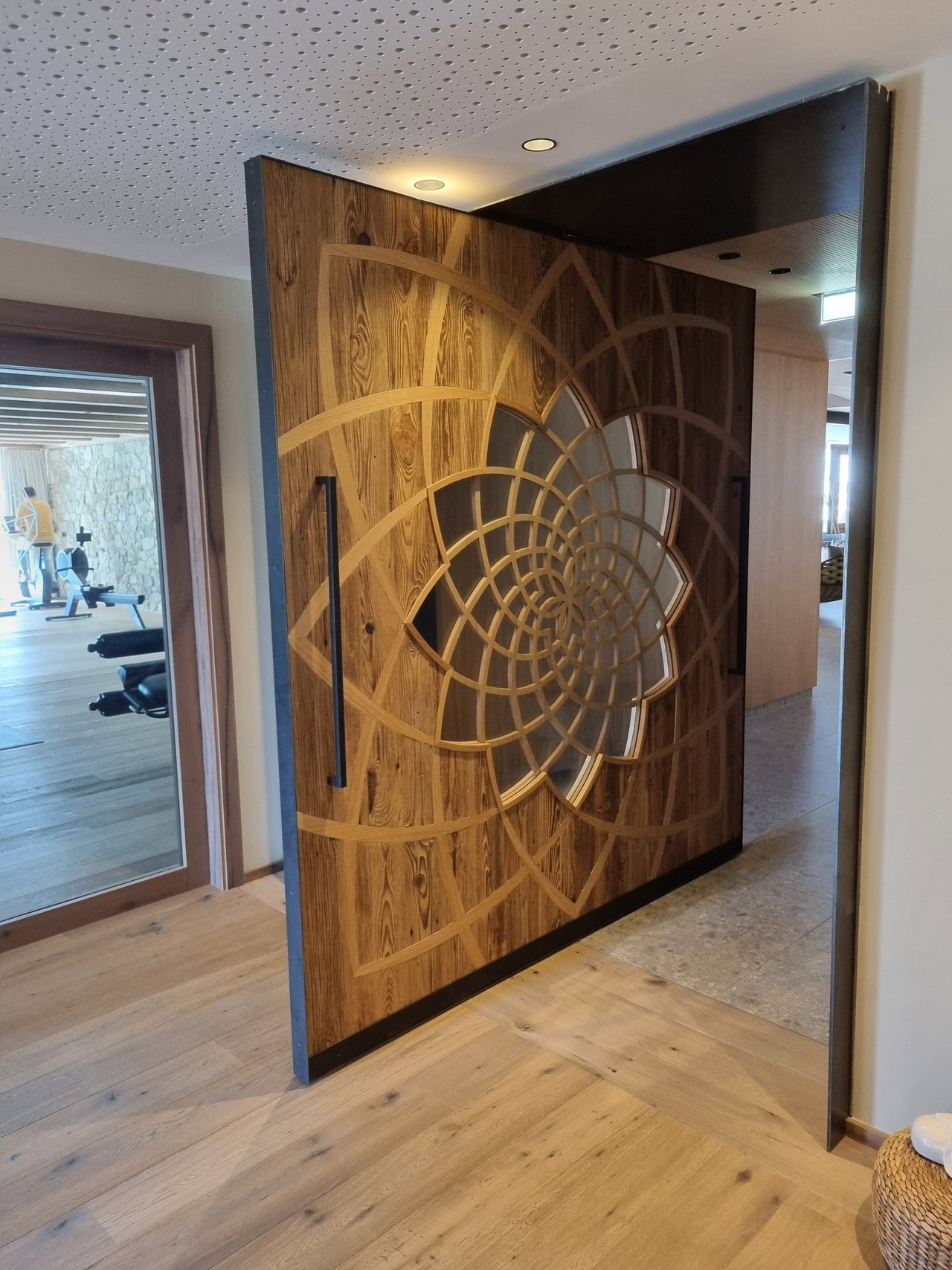Wooden pivot door in a hotel in Mittersill with FritsJurgens System 3 pivot hinge system inside