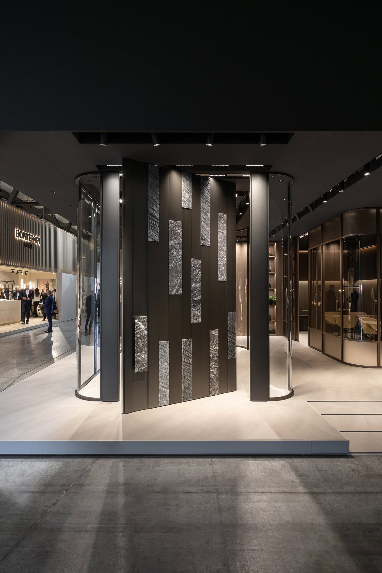 Wooden pivot door in a showroom in Milan with FritsJurgens System One pivot hinge system inside