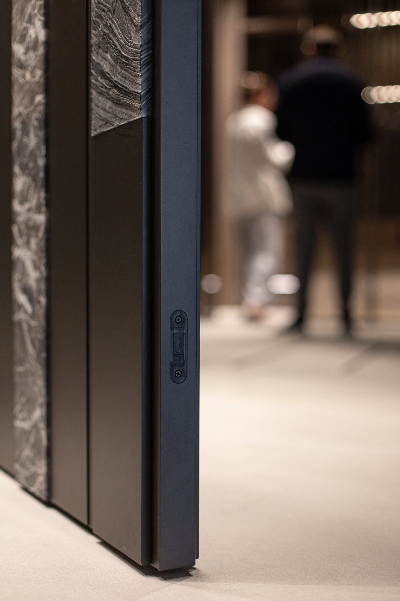 Wooden pivot door in a showroom in Milan with FritsJurgens System One pivot hinge system inside