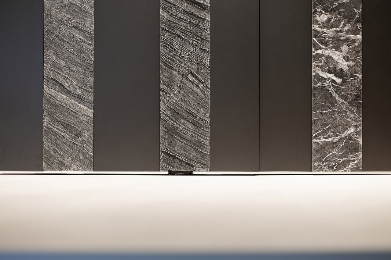 Wooden pivot door in a showroom in Milan with FritsJurgens System One pivot hinge system inside
