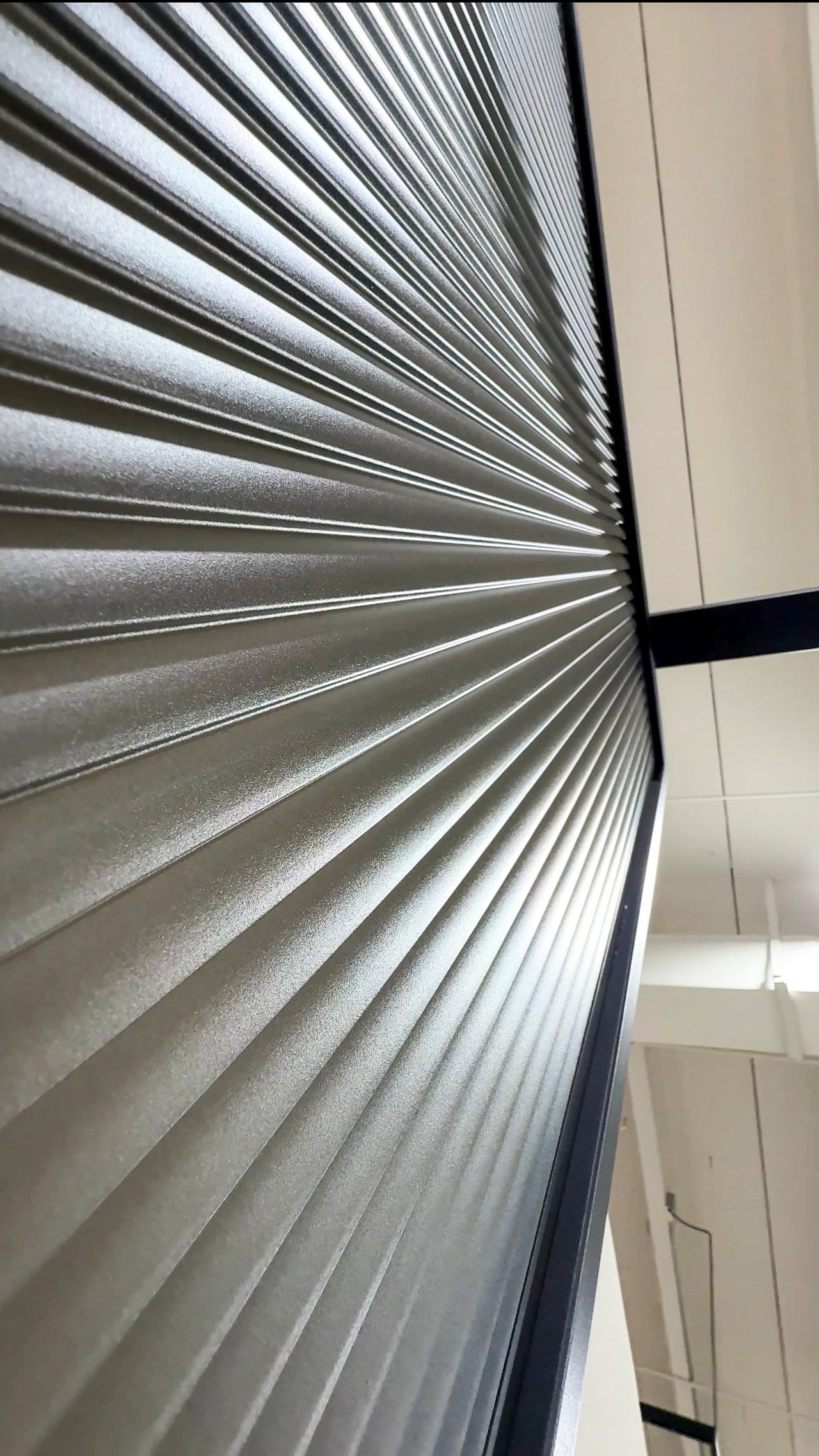 Steel and glass pivot door in a showroom in Miami with FritsJurgens System M+ pivot hinge system inside