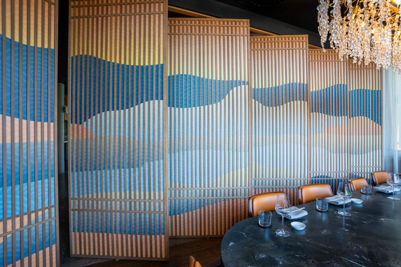 Wooden pivot door in a restaurant with FritsJurgens System One pivot hinge system inside