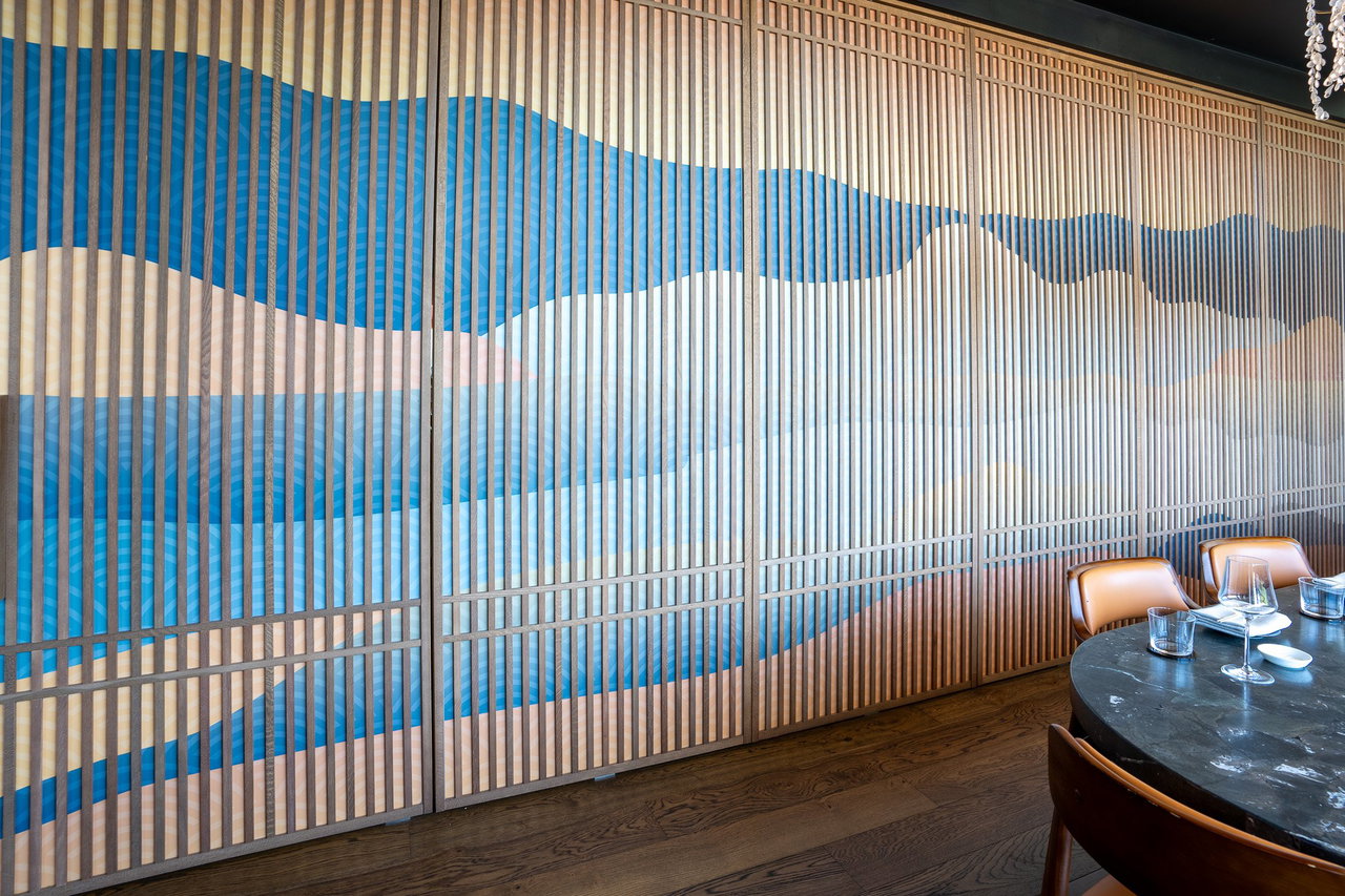Wooden pivot door in a restaurant with FritsJurgens System One pivot hinge system inside