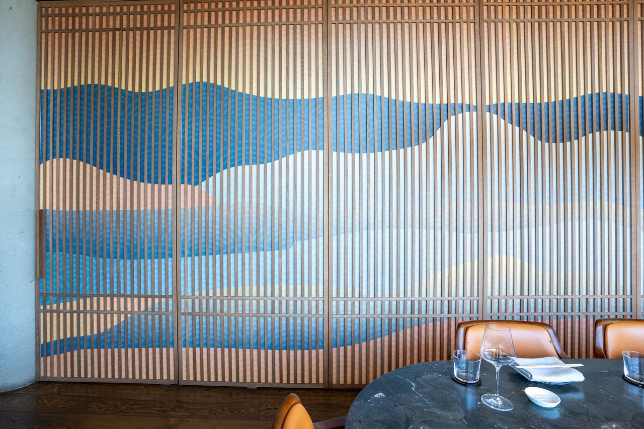 Wooden pivot door in a restaurant with FritsJurgens System One pivot hinge system inside