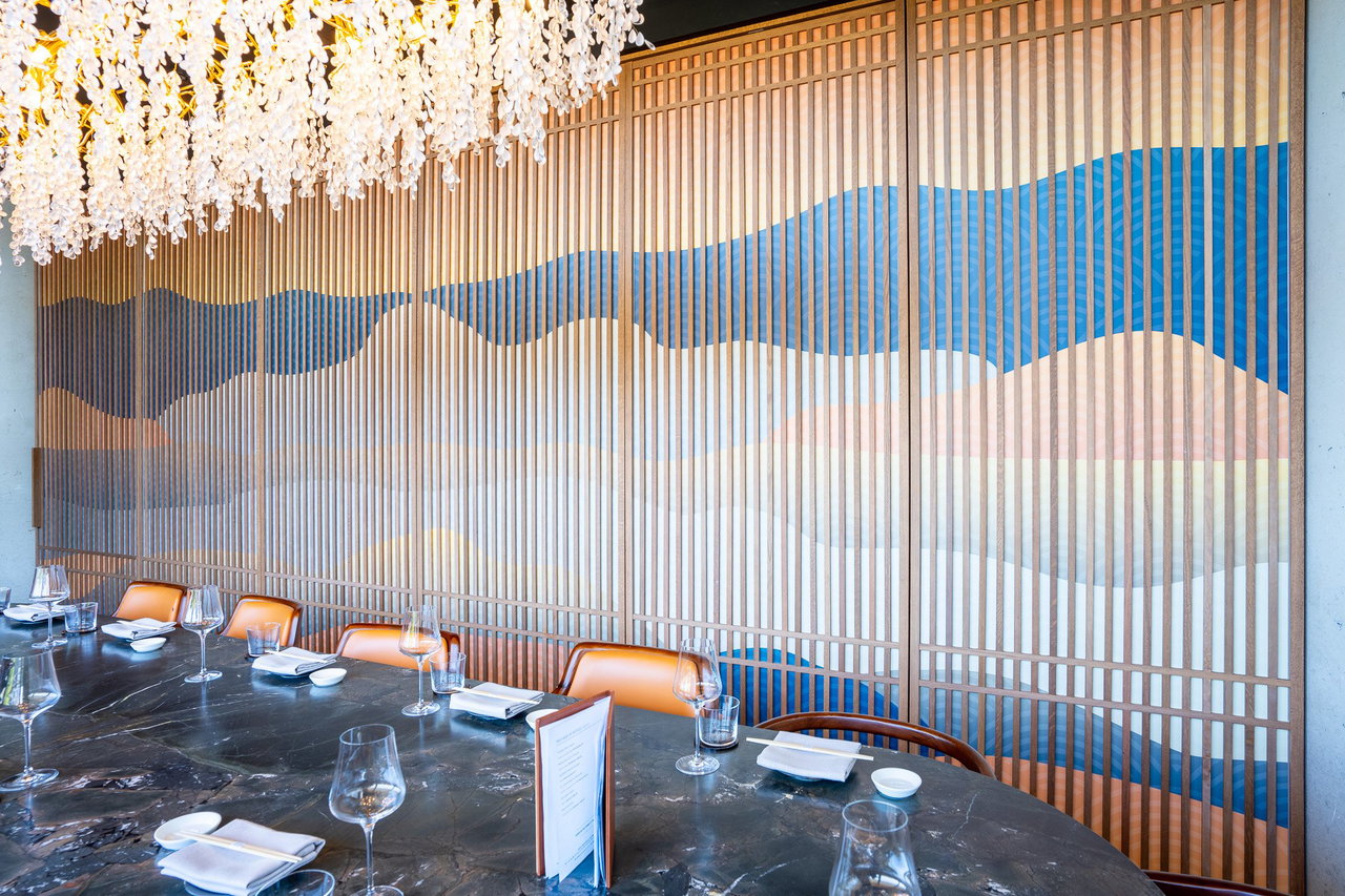 Wooden pivot door in a restaurant with FritsJurgens System One pivot hinge system inside