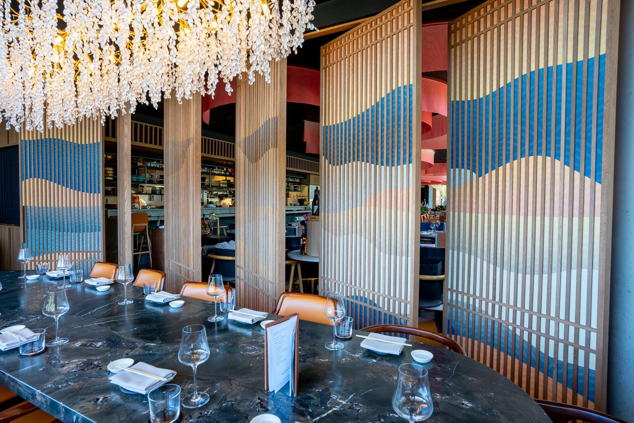 Wooden pivot door in a restaurant with FritsJurgens System One pivot hinge system inside