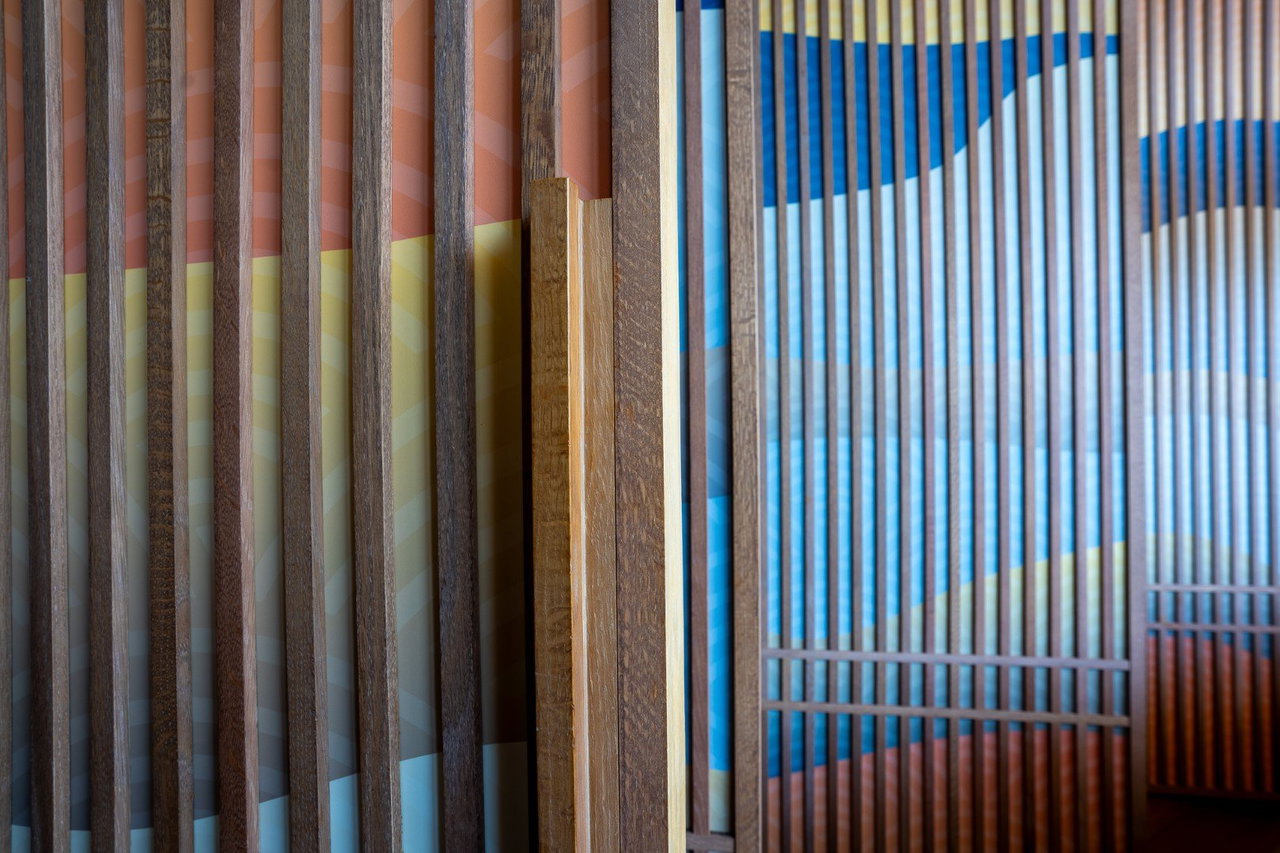 Wooden pivot door in a restaurant with FritsJurgens System One pivot hinge system inside