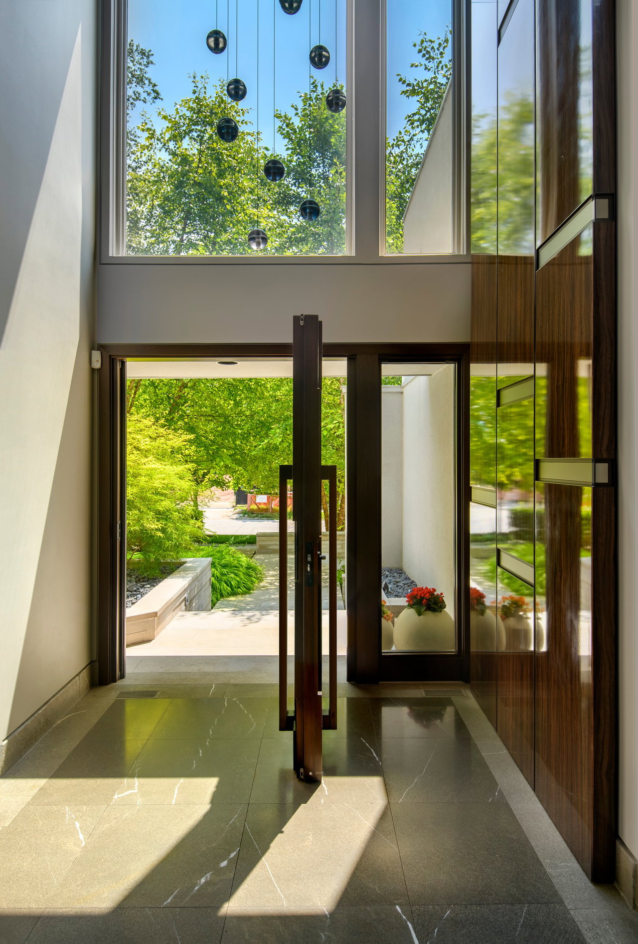 Wooden pivot door in a private home in Toronto with FritsJurgens System One pivot hinge system inside