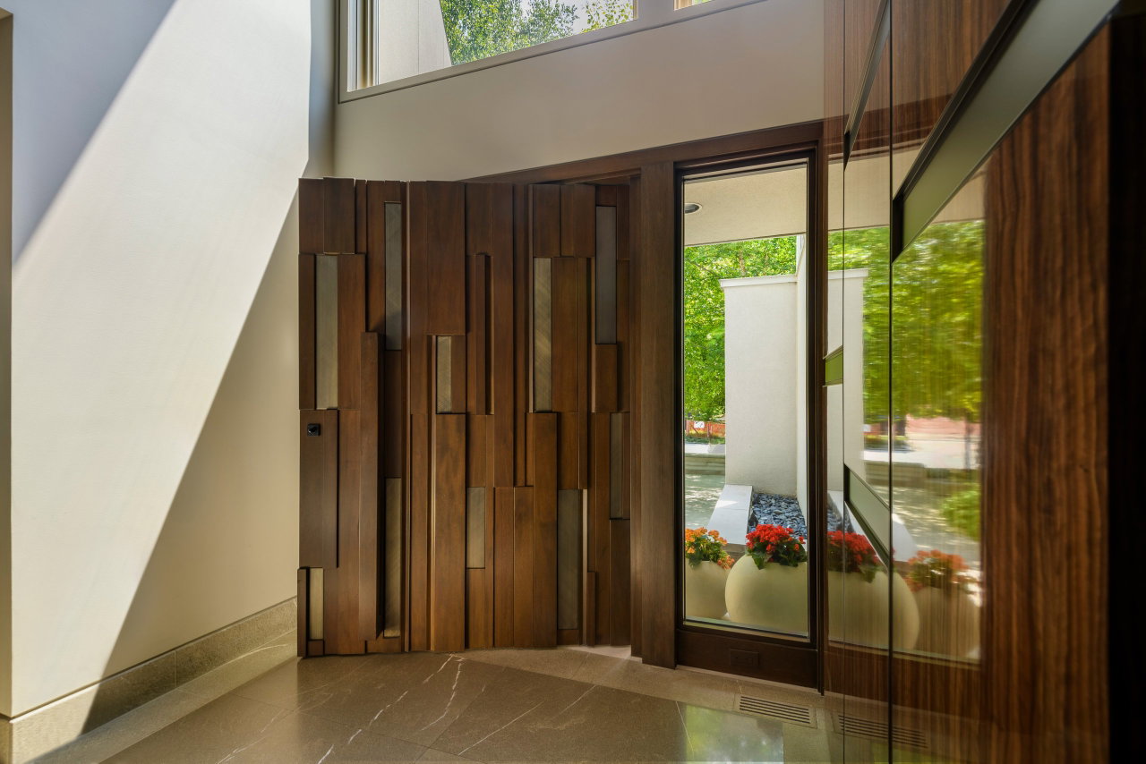 Wooden pivot door in a private home in Toronto with FritsJurgens System One pivot hinge system inside
