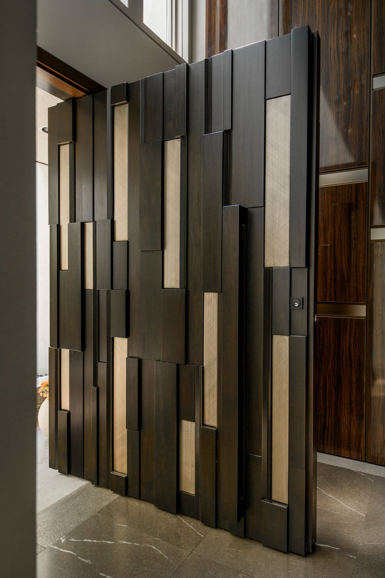 Wooden pivot door in a private home in Toronto with FritsJurgens System One pivot hinge system inside