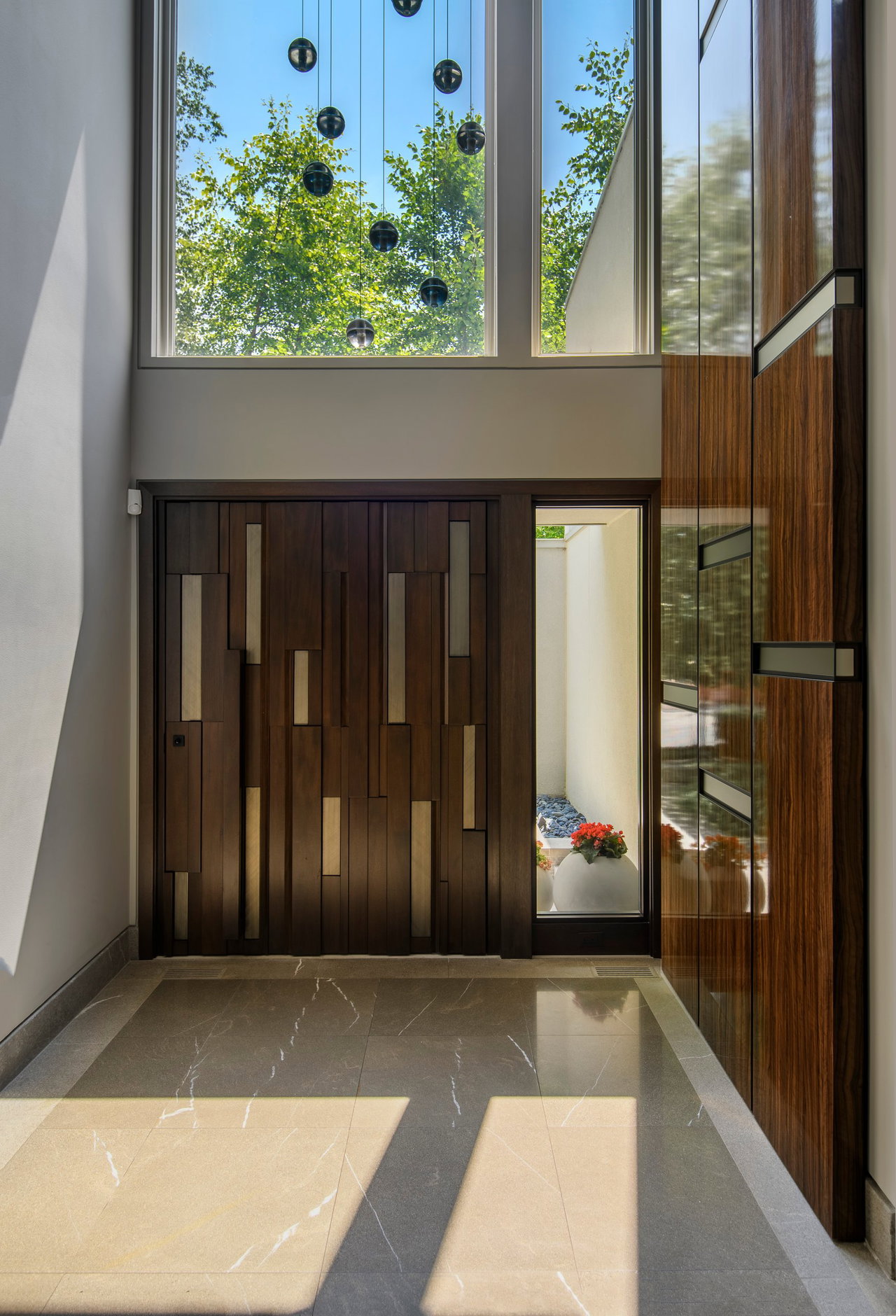 Wooden pivot door in a private home in Toronto with FritsJurgens System One pivot hinge system inside