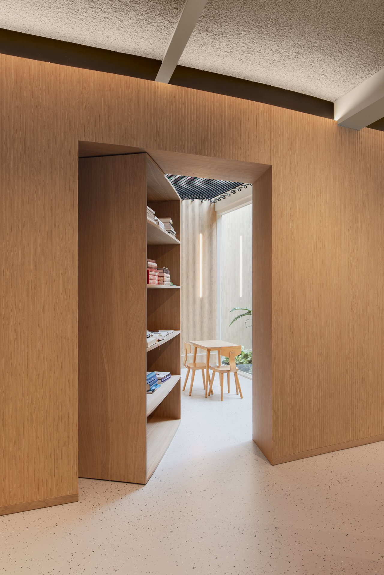 Wooden pivot door in a private home in Amsterdam with FritsJurgens System One pivot hinge system inside